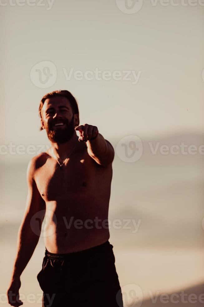 An athlete rests on top of a mountain after exhausting running training. photo