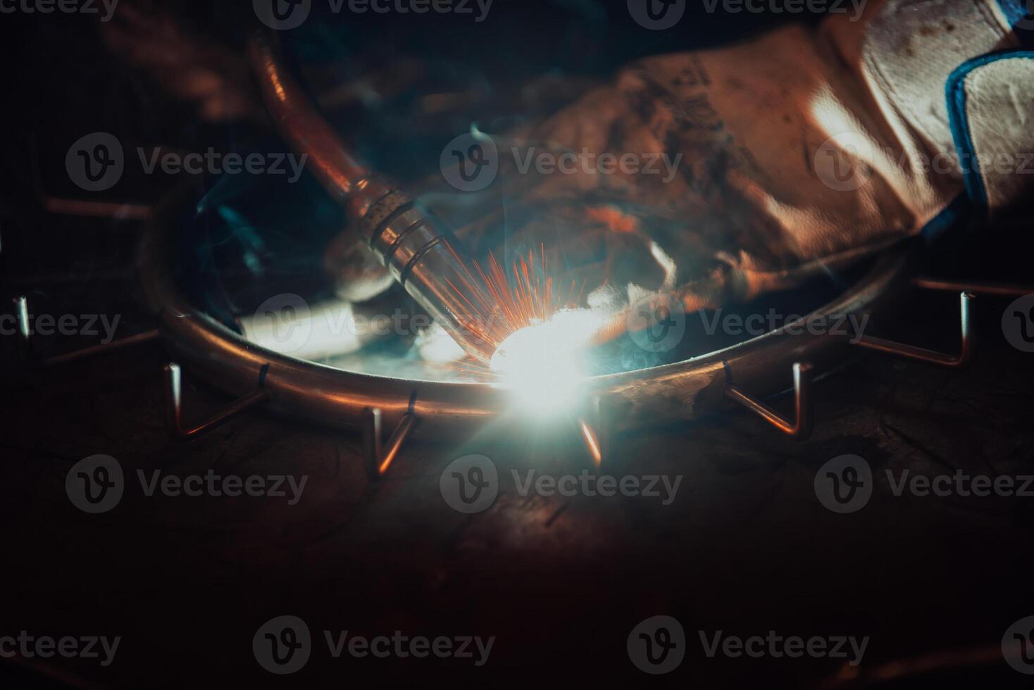 Close up of the steel welding process. Work in the heavy steel industry photo