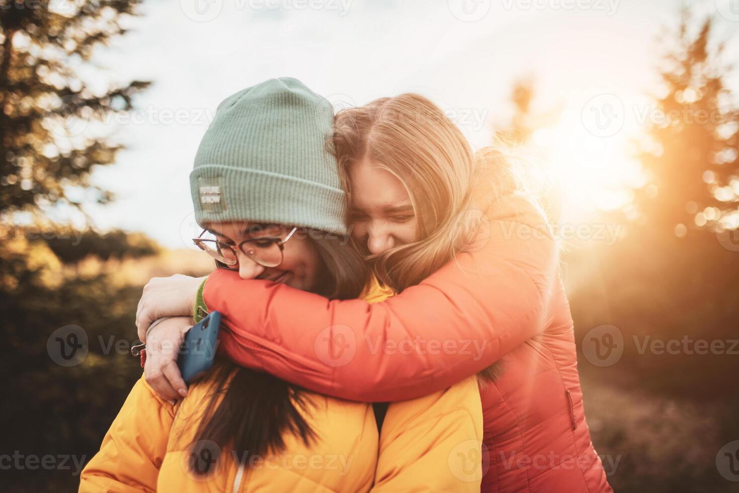 two girls embracing in nature photo