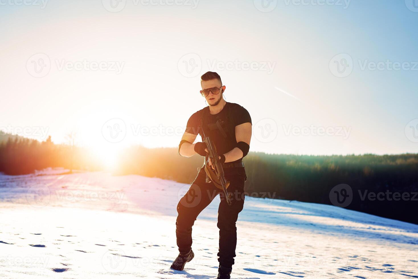 soldier with weapons in forest somewhere above the Arctic Circle photo