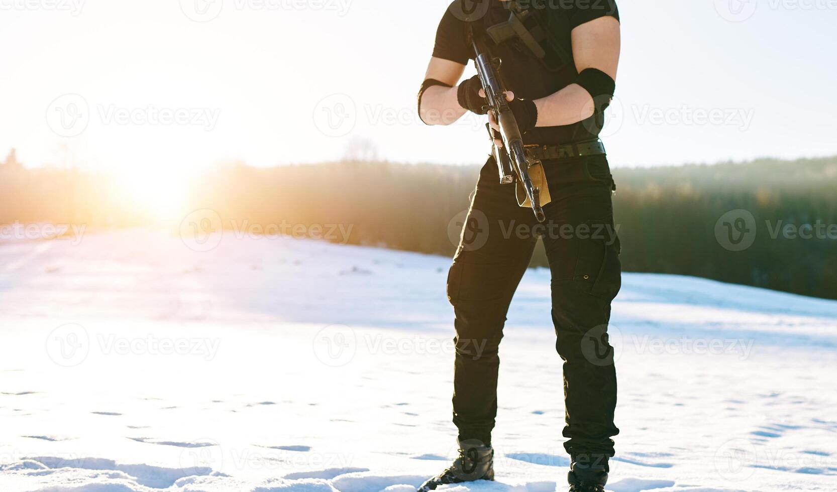 soldier with weapons in forest somewhere above the Arctic Circle photo