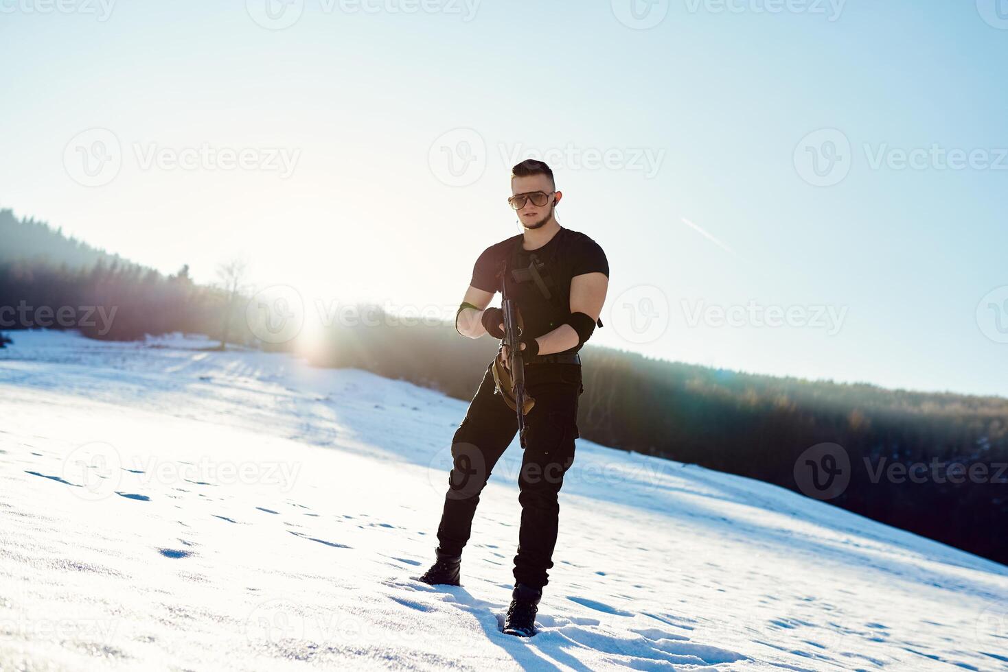 soldier with weapons in forest somewhere above the Arctic Circle photo