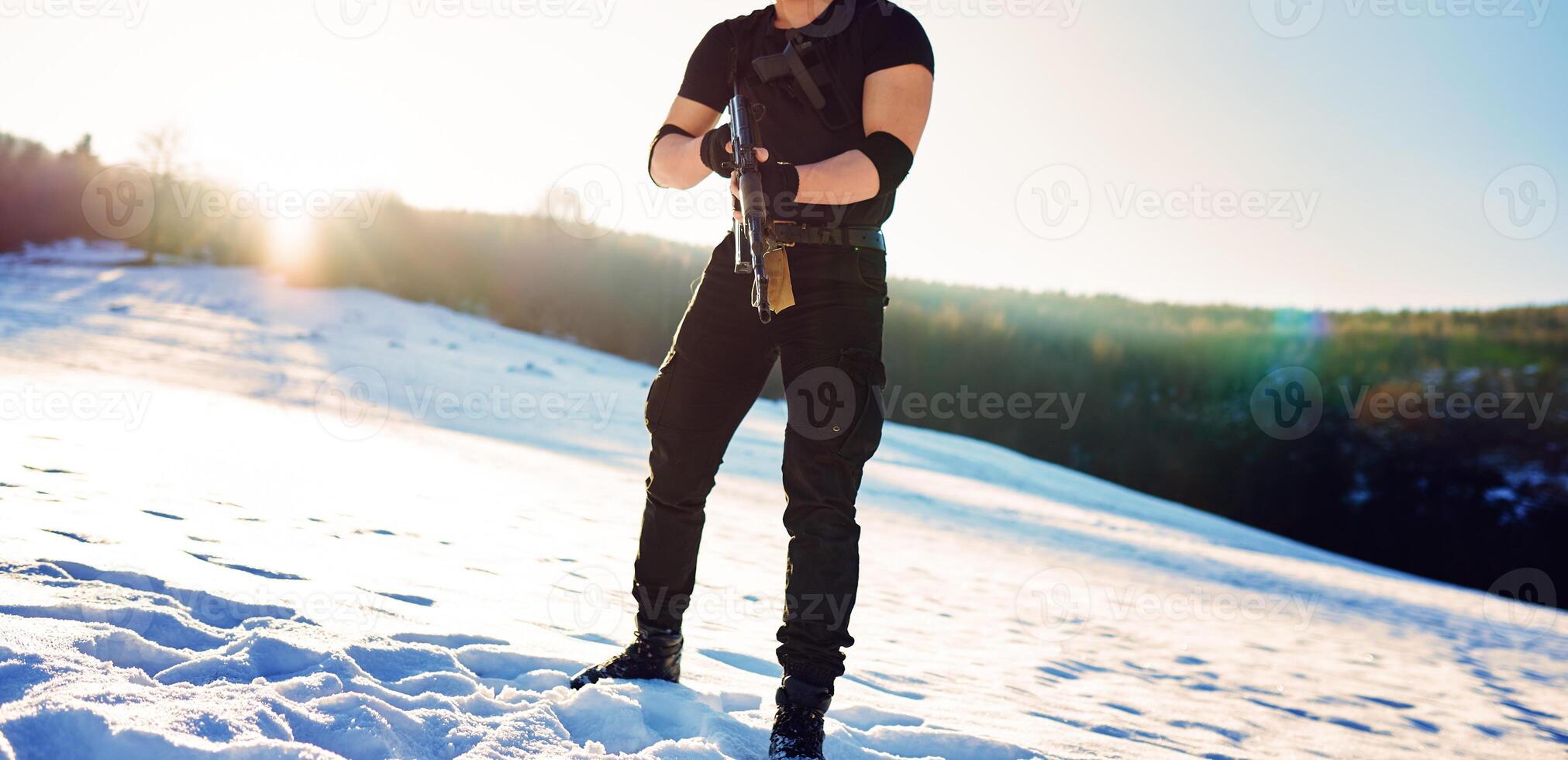 soldier with weapons in forest somewhere above the Arctic Circle photo