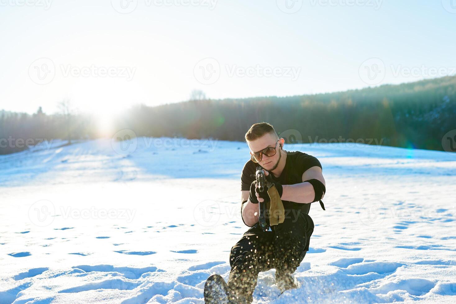 soldier with weapons in forest somewhere above the Arctic Circle photo