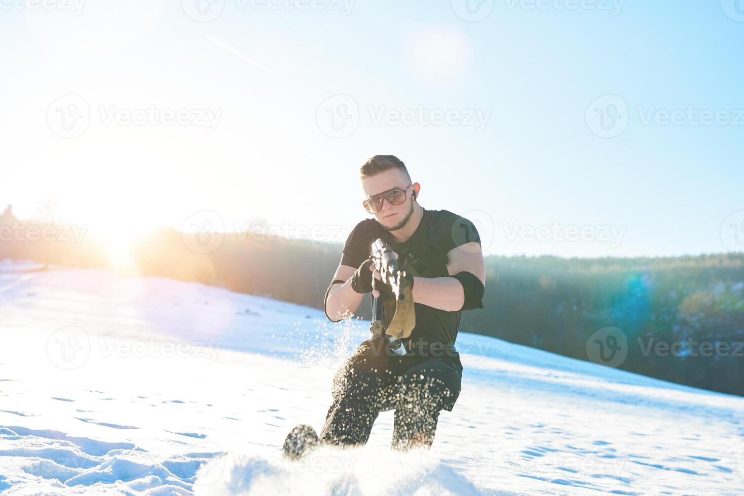 soldier with weapons in forest somewhere above the Arctic Circle photo
