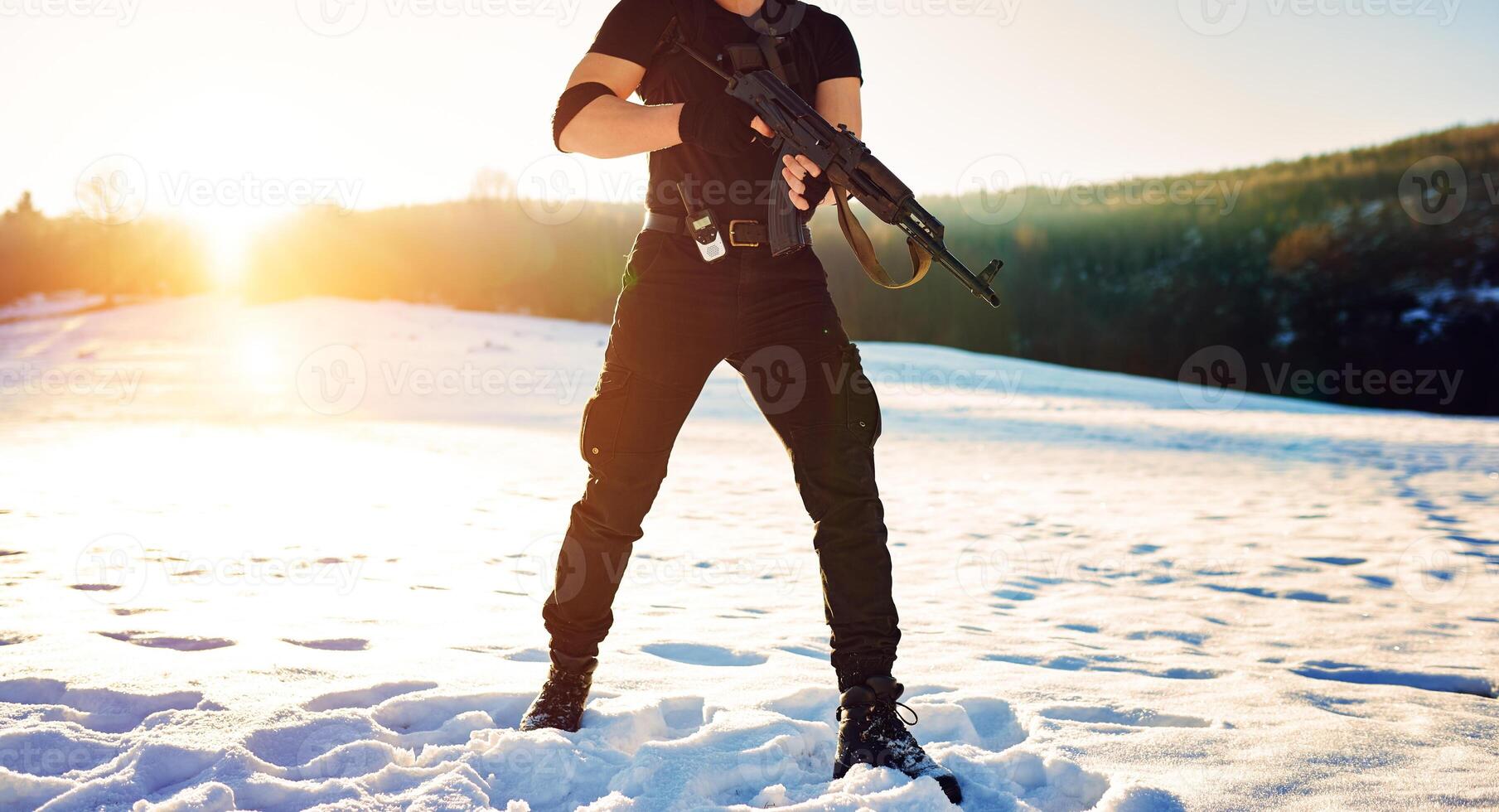 soldier with weapons in forest somewhere above the Arctic Circle photo
