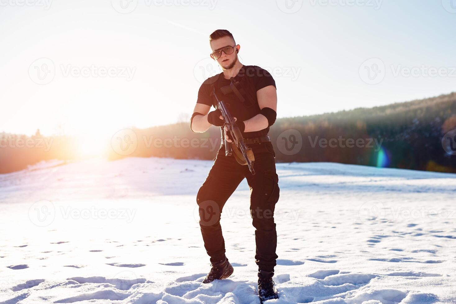soldier with weapons in forest somewhere above the Arctic Circle photo