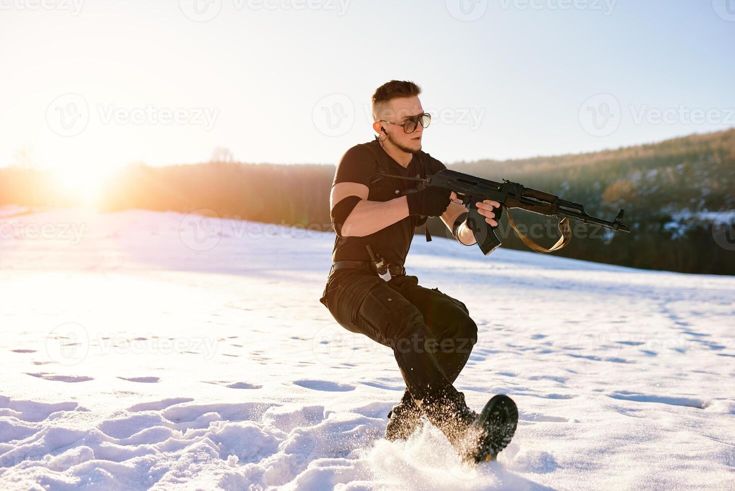 soldier with weapons in forest somewhere above the Arctic Circle photo