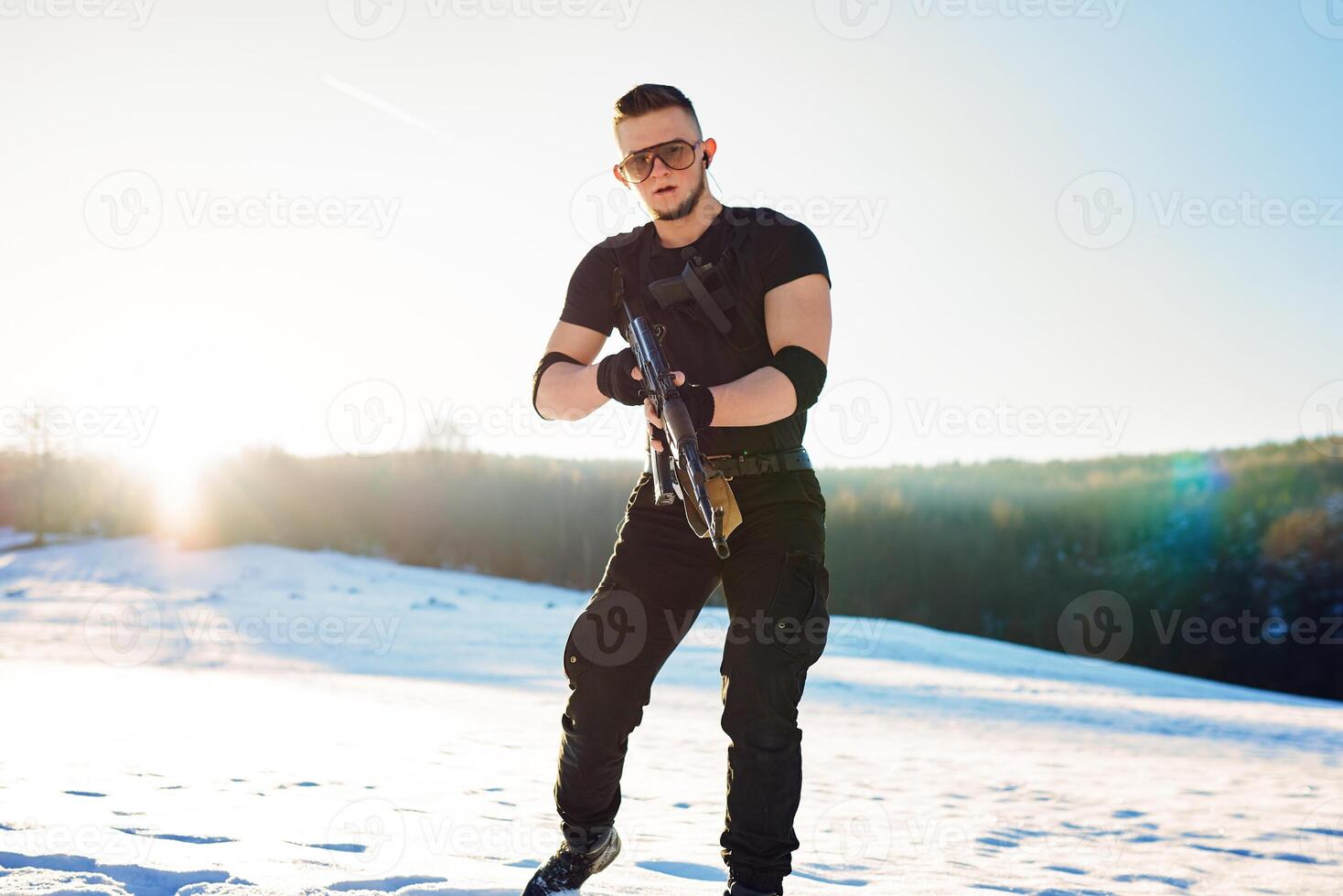 soldier with weapons in forest somewhere above the Arctic Circle photo