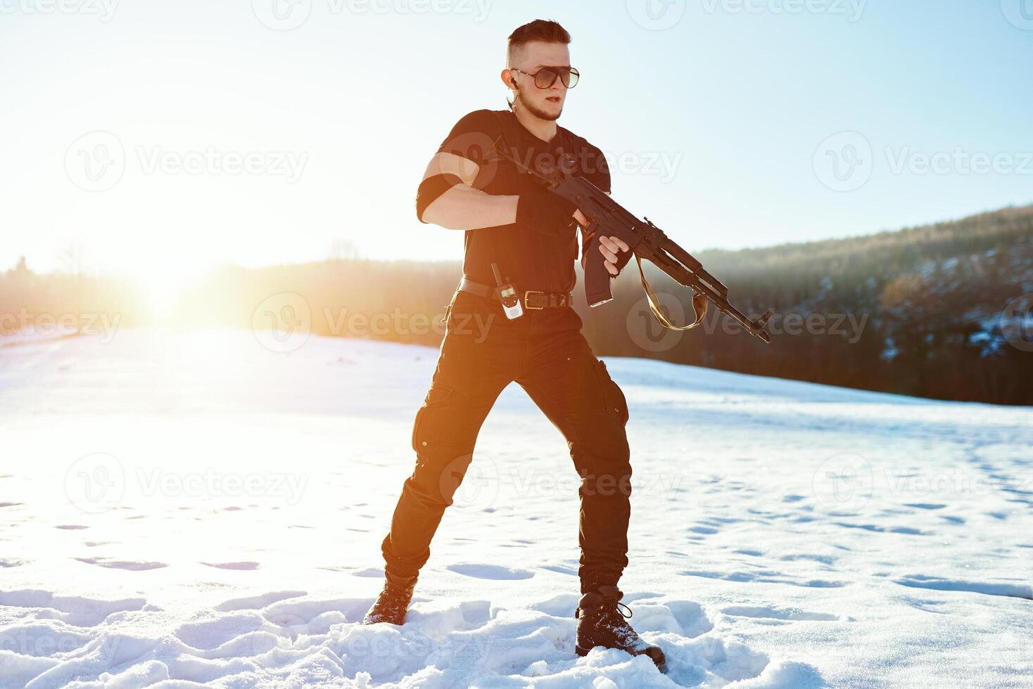 soldier with weapons in forest somewhere above the Arctic Circle photo