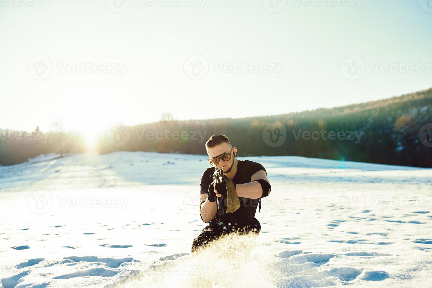 soldier with weapons in forest somewhere above the Arctic Circle photo