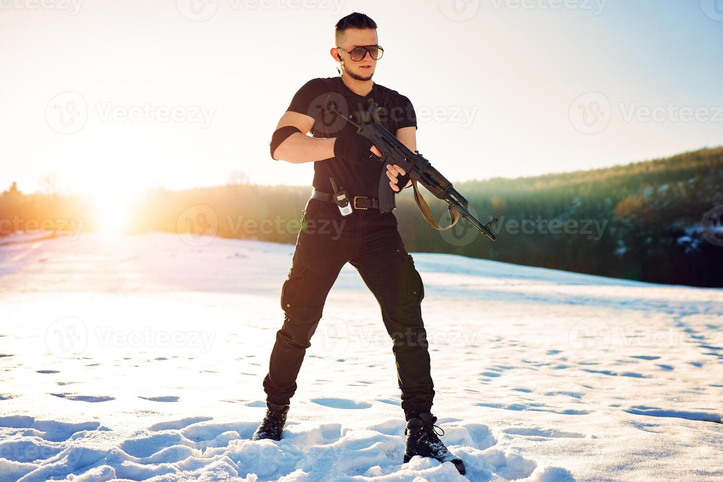 soldier with weapons in forest somewhere above the Arctic Circle photo