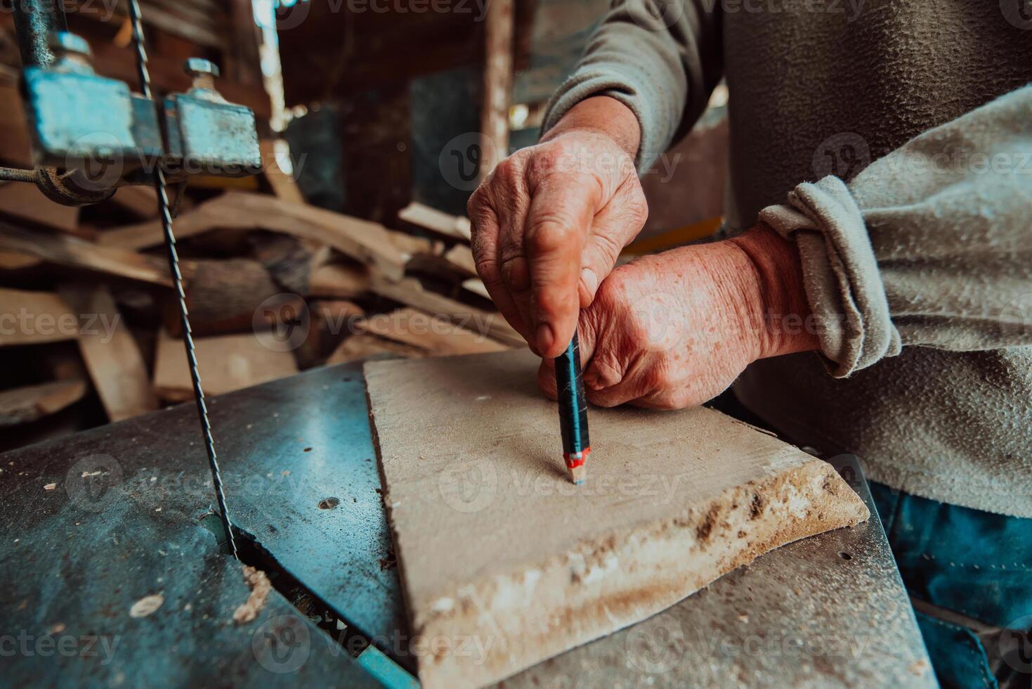 Closeup photo of a senior man outlining wood and preparing it for processing