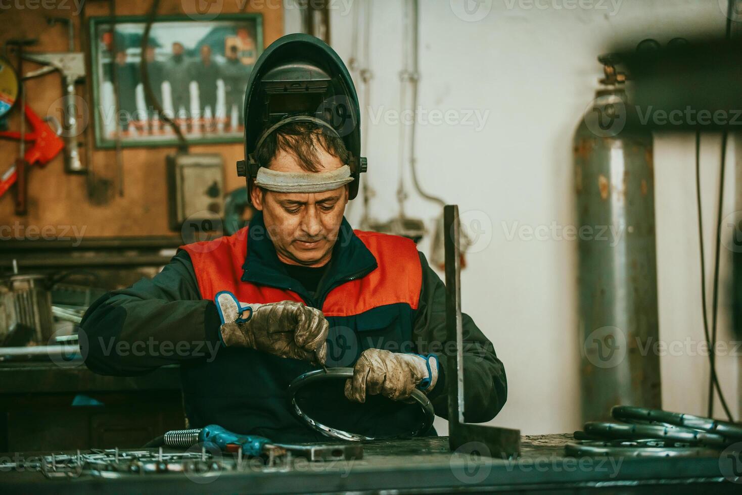 A worker in an industry preparing iron structures for welding photo
