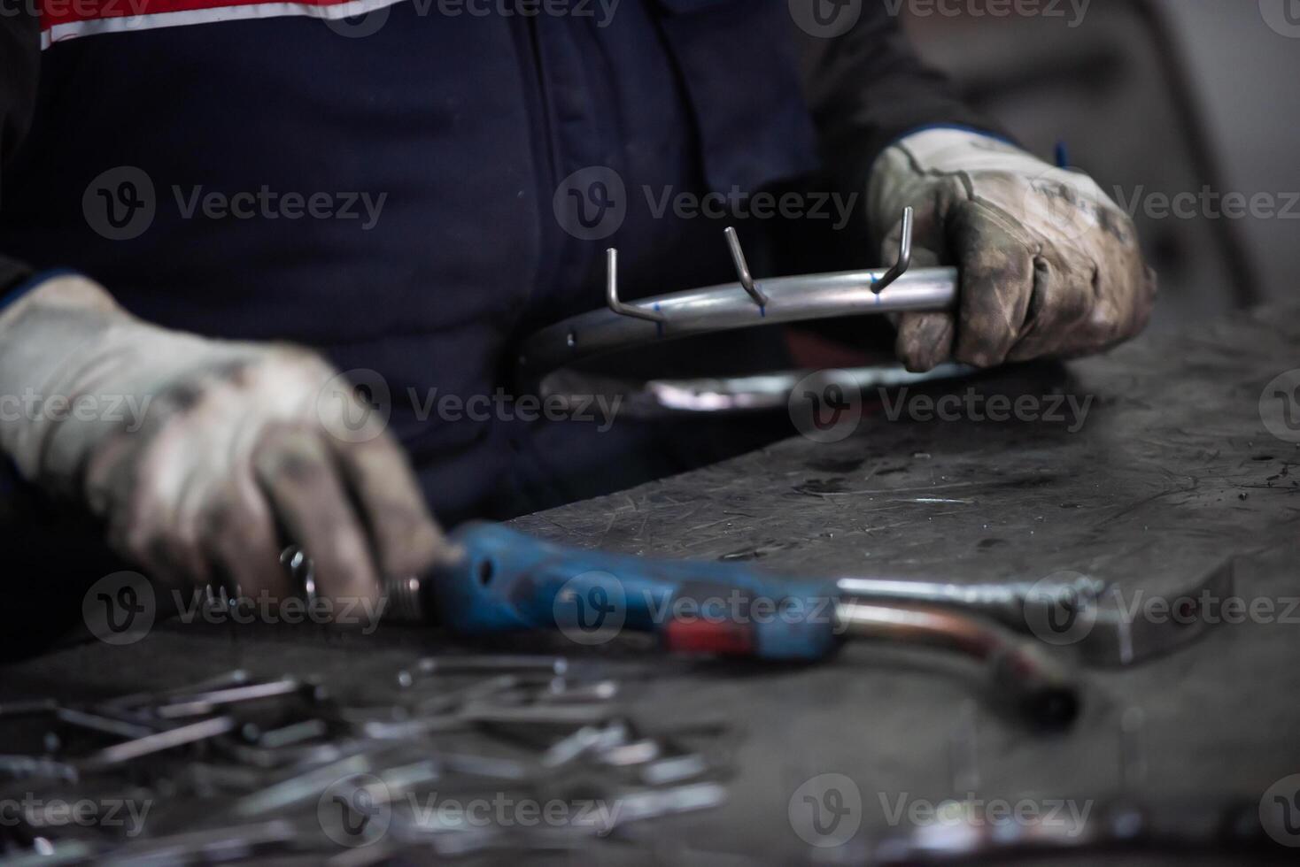 A worker in an industry preparing iron structures for welding photo