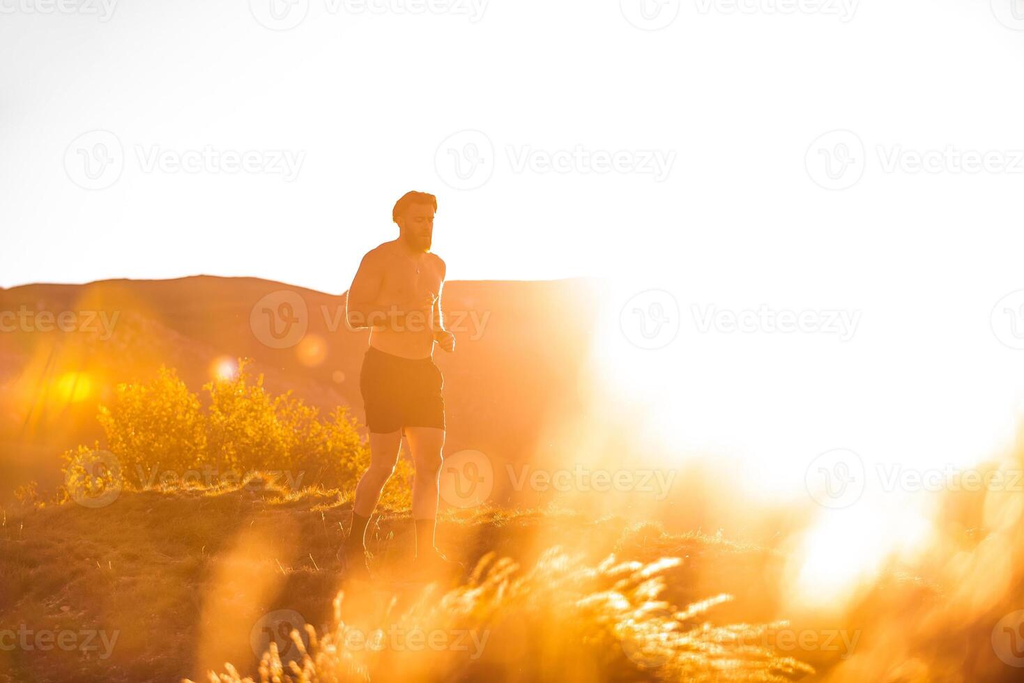 Athletic young man running in the nature. Healthy lifestyle photo