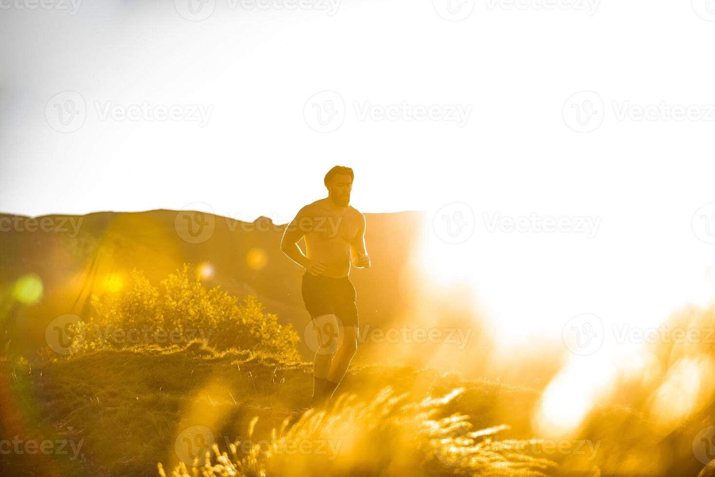 Athletic young man running in the nature. Healthy lifestyle photo