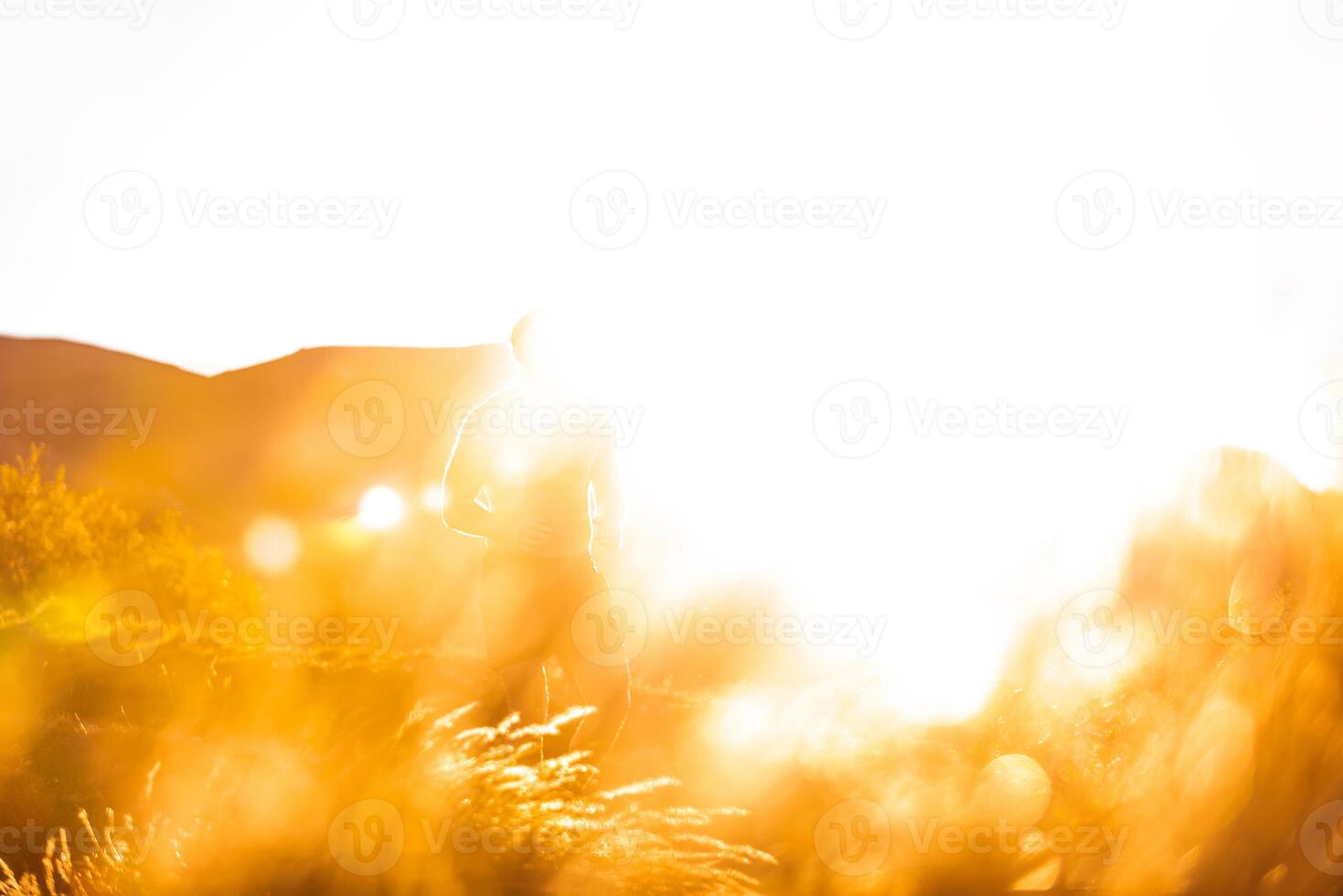 Mountain range with visible silhouettes through the morning colorful fog photo