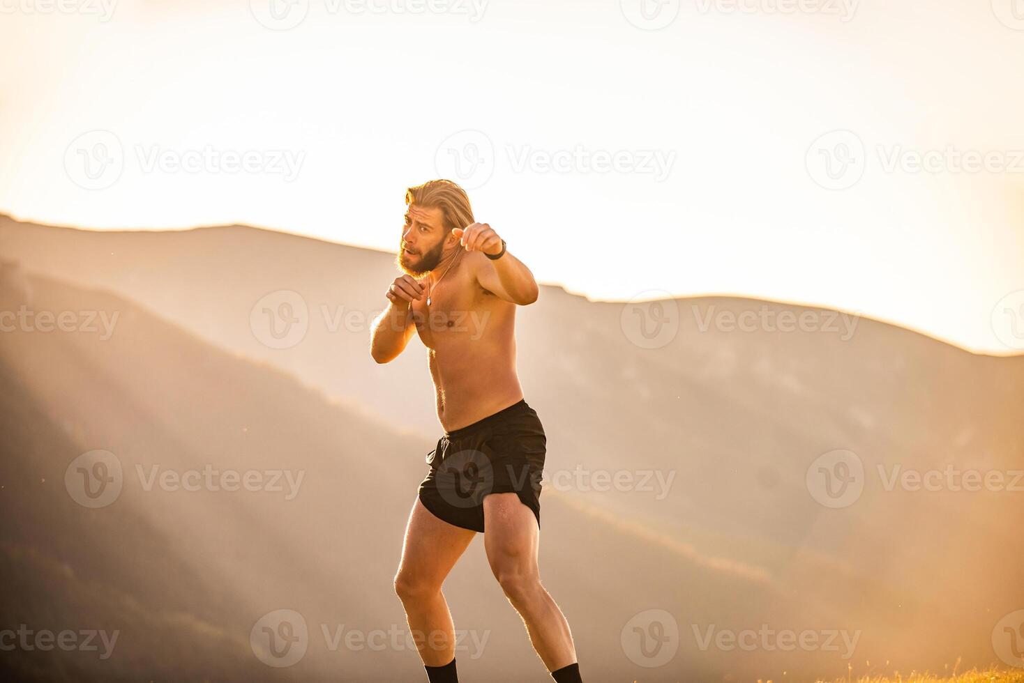 Man boxing with shadow exercising at sunset outdoor. Port victory healthy lifestyle concept. Man shadow boxing little champion boxer silhouette sun photo
