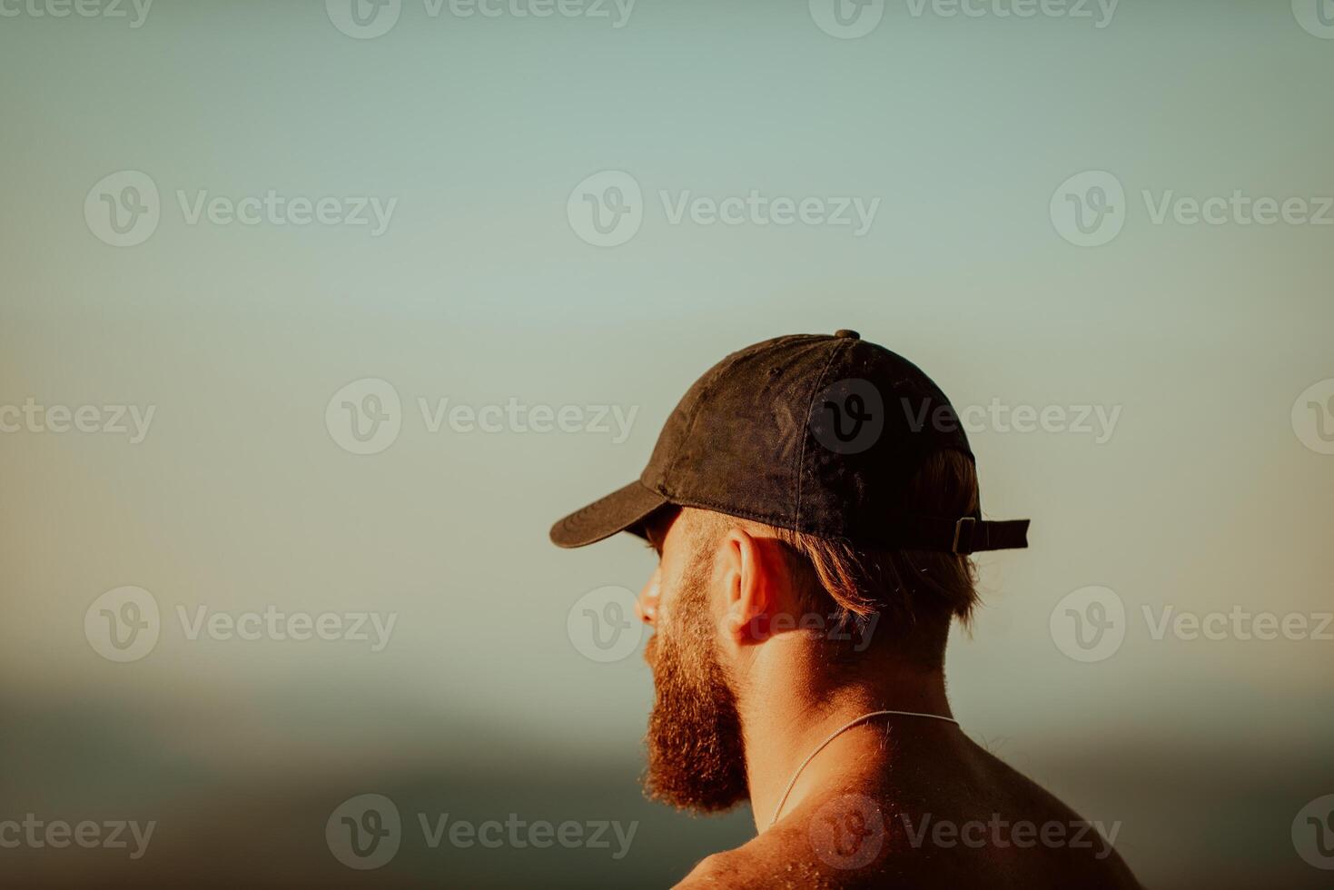 An athlete rests on top of a mountain after exhausting running training. photo