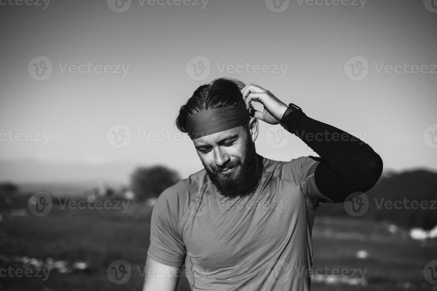 A determined athlete preparing for the start of training on the top of the mountain at sunrise. photo