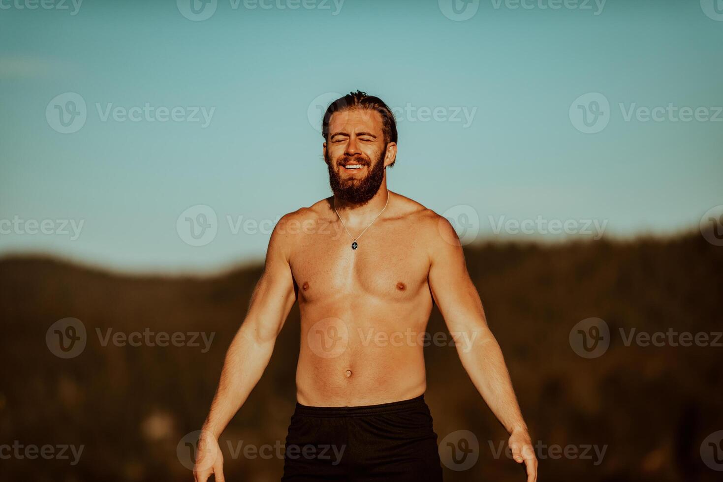 An athlete rests on top of a mountain after exhausting running training. photo