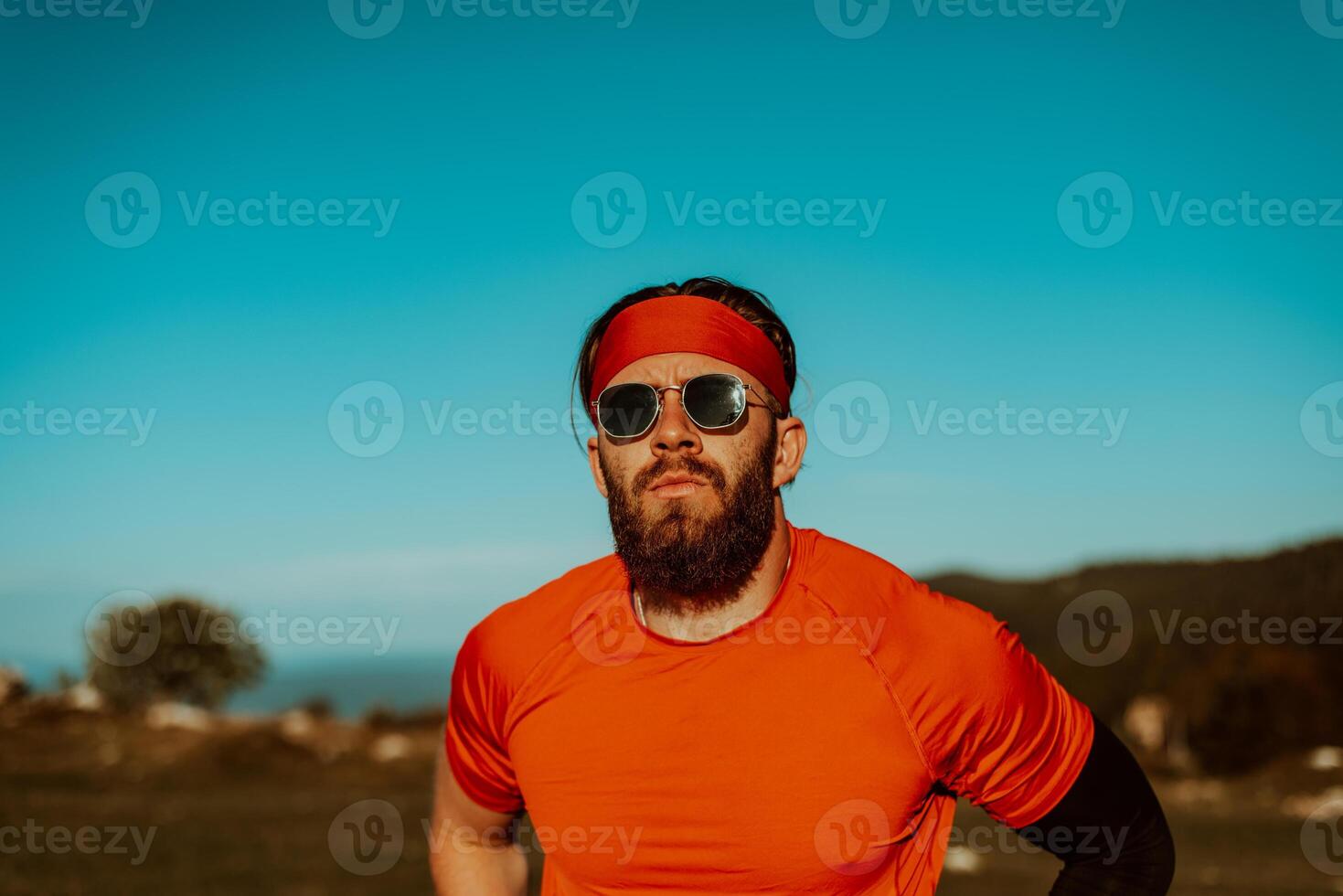 A determined athlete preparing for the start of training on the top of the mountain at sunrise. photo