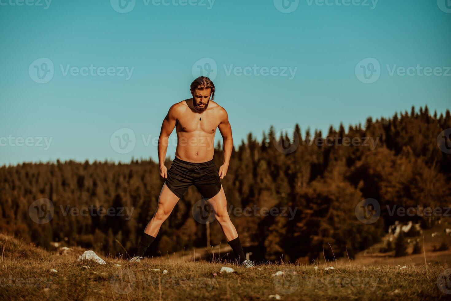 A man stretching after a hard workout in the early hours of the morning photo