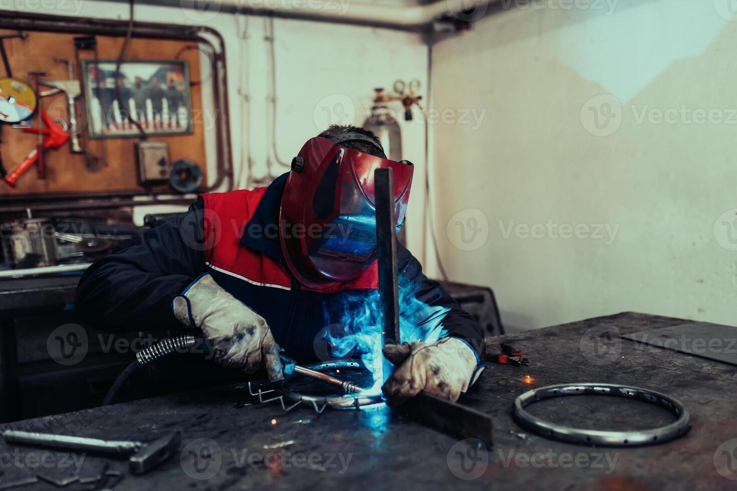 Welder erecting technical steel. Industrial steel welder in factory technical photo