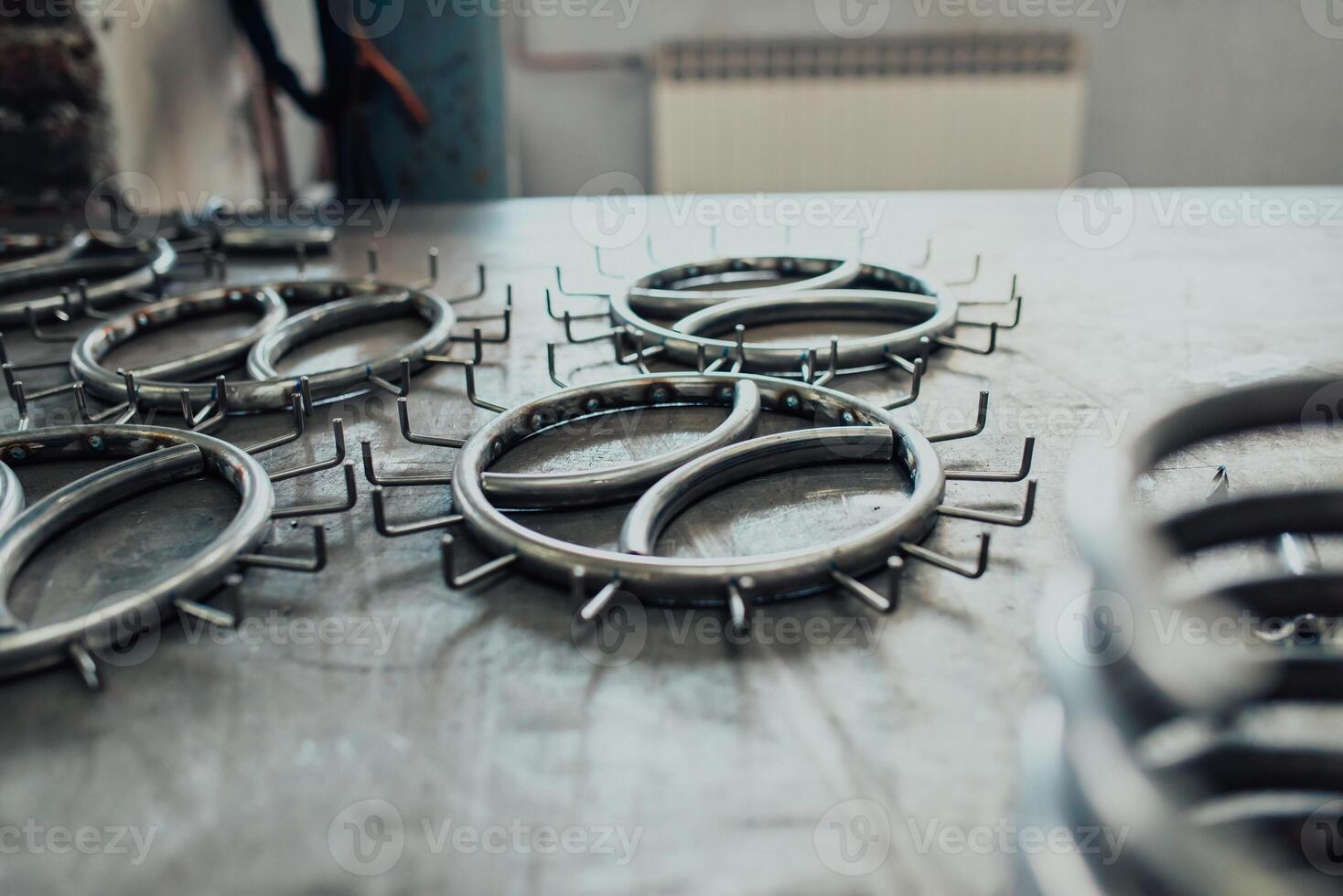 Pieces of steel lined up on the table ready for the welding process photo