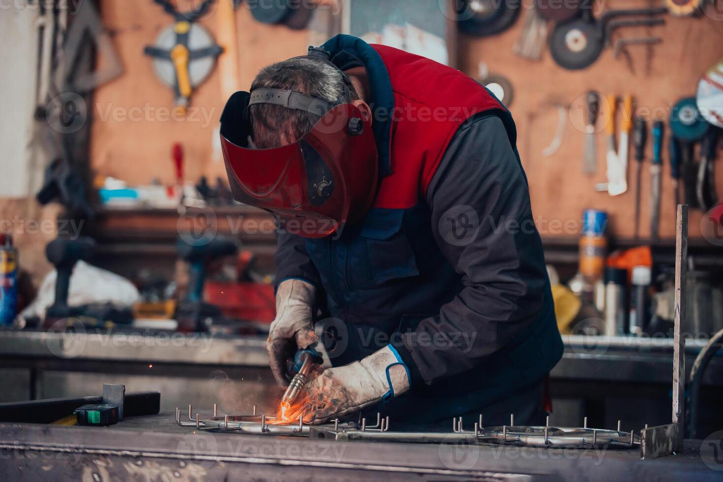 Welder erecting technical steel. Industrial steel welder in factory technical photo