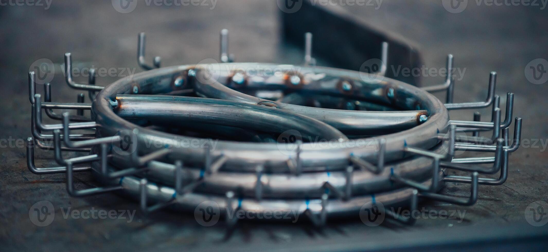 Pieces of steel lined up on the table ready for the welding process photo