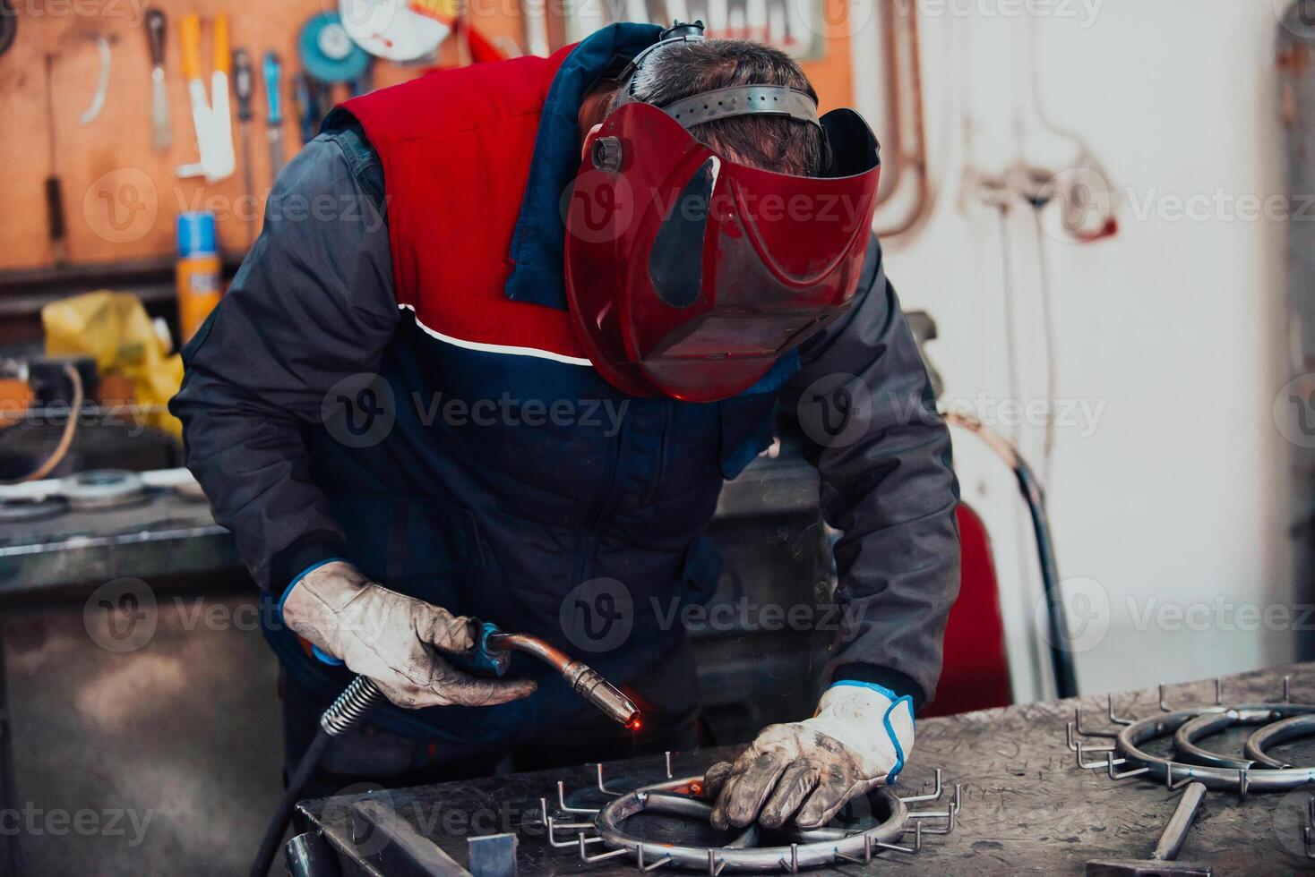 Welder erecting technical steel. Industrial steel welder in factory technical photo