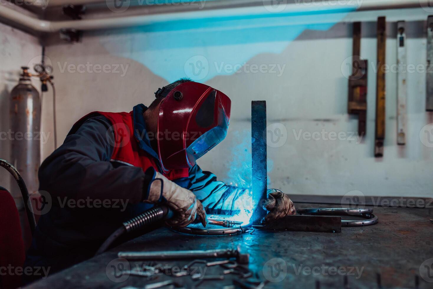 Welder erecting technical steel. Industrial steel welder in factory technical photo