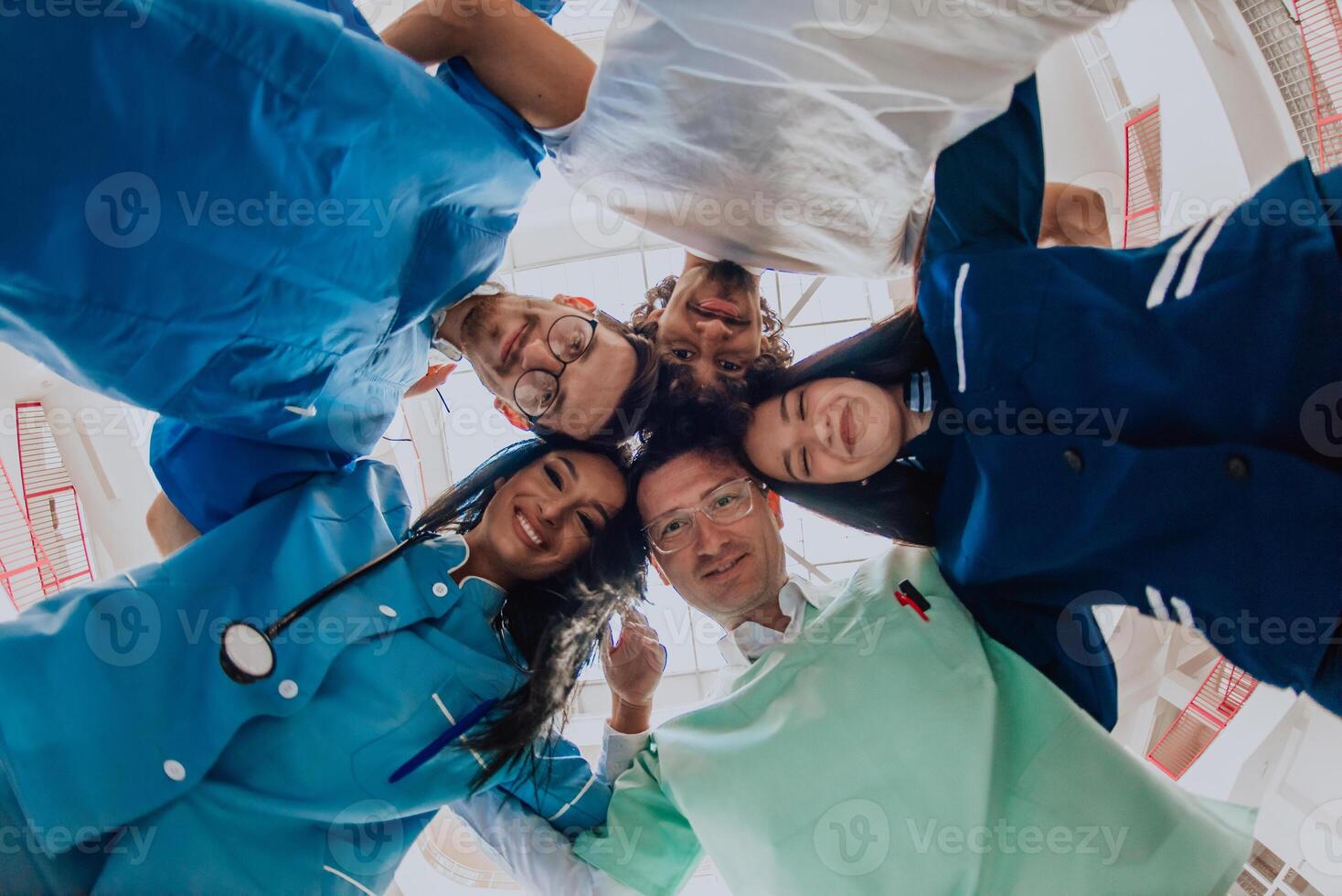 Group of doctors a medical nurse, and a surgeon are captured in a heartfelt embrace, showcasing their unity, teamwork, and profound connection in the healthcare field. photo