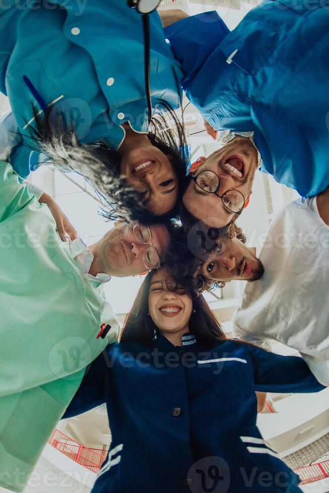 Group of doctors a medical nurse, and a surgeon are captured in a heartfelt embrace, showcasing their unity, teamwork, and profound connection in the healthcare field. photo