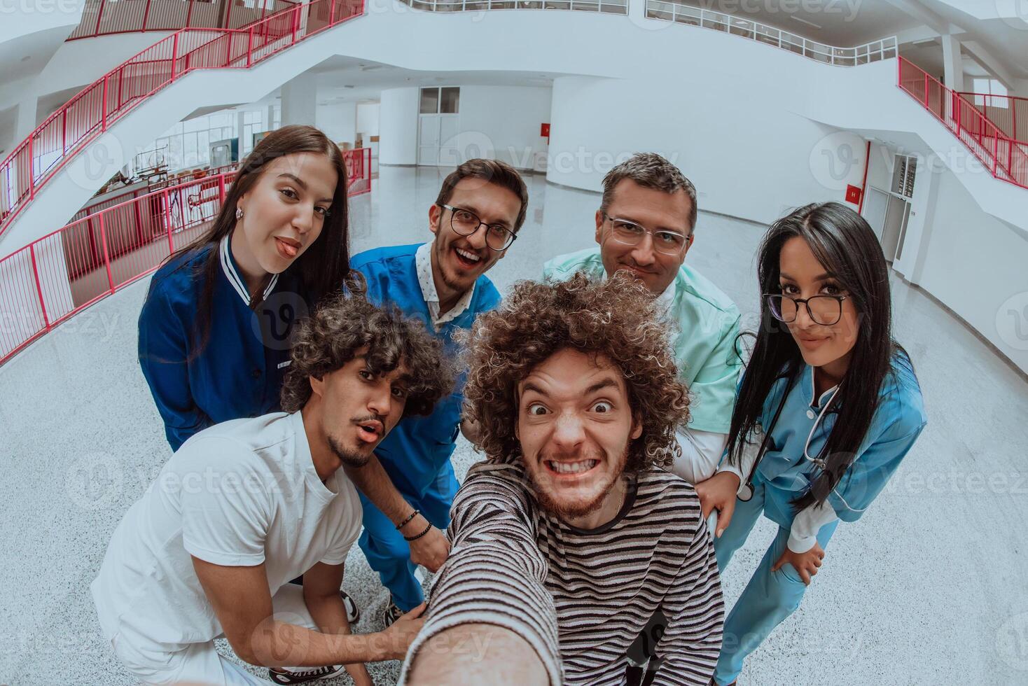 In a modern hospital hallway, a doctor and a medical nurse capture a selfie with a wheelchair patient, radiating joy, inclusivity, and the positive impact of technology in healthcare. photo
