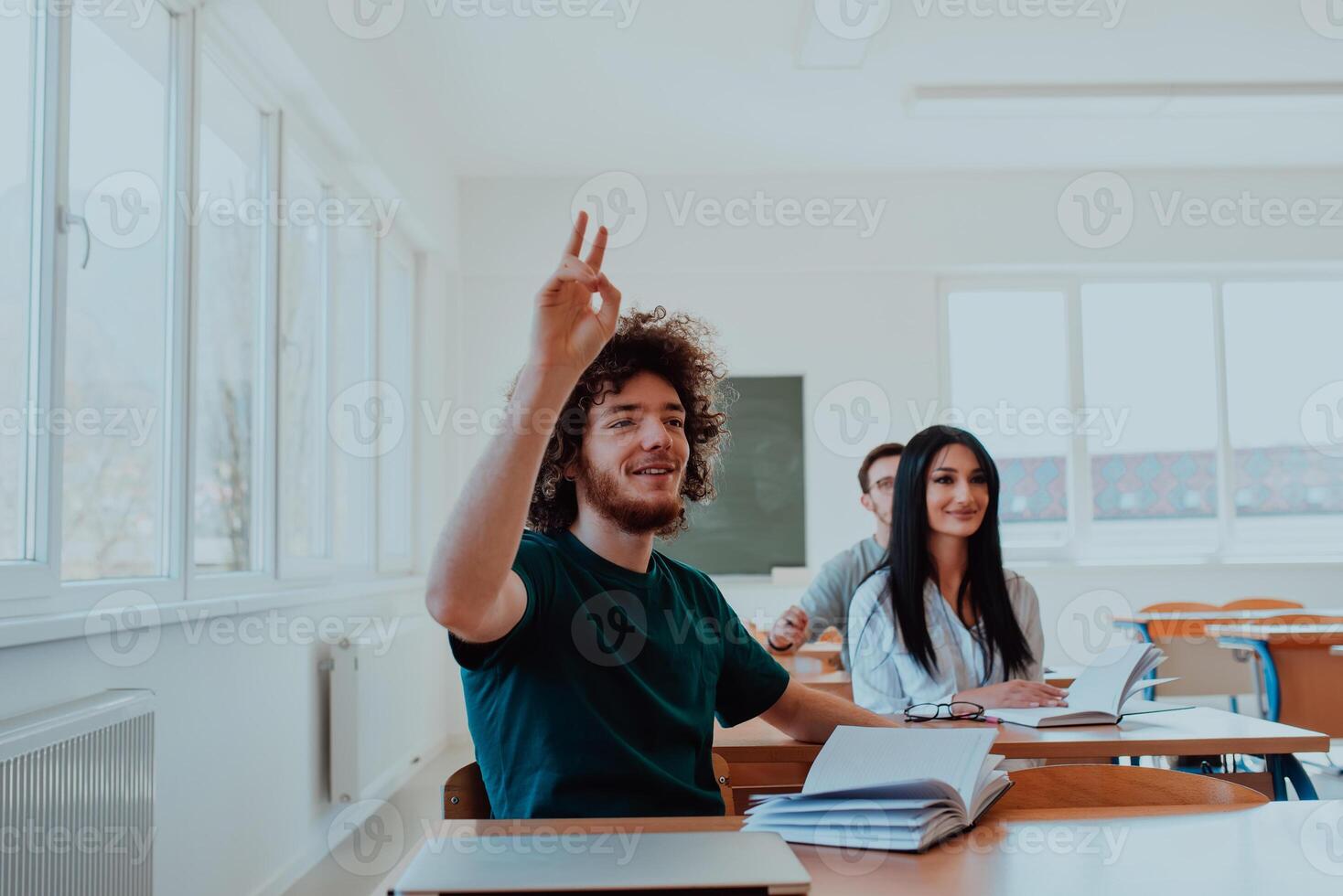 A diverse group of students is attentively listening, actively participating, and embracing modern education in a dynamic classroom setting, fostering collaboration and stimulating creativity. photo