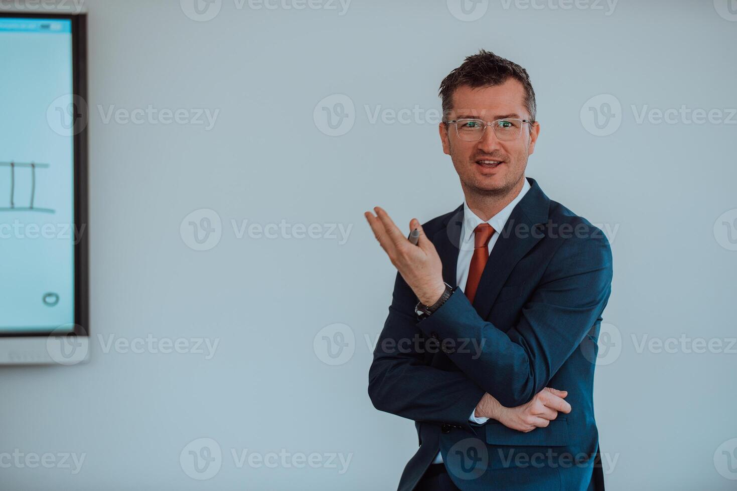 A modernly dressed professor engages in educating students, who listen attentively, creating a dynamic scene of knowledge-sharing and focused learning in the classroom. photo
