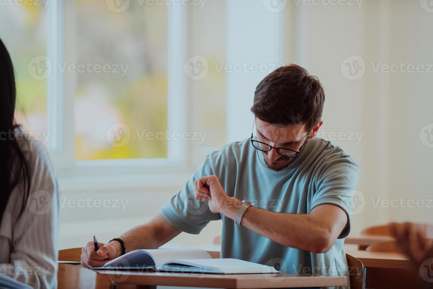 A Student Watches the Clock, Longing for the End of Class photo