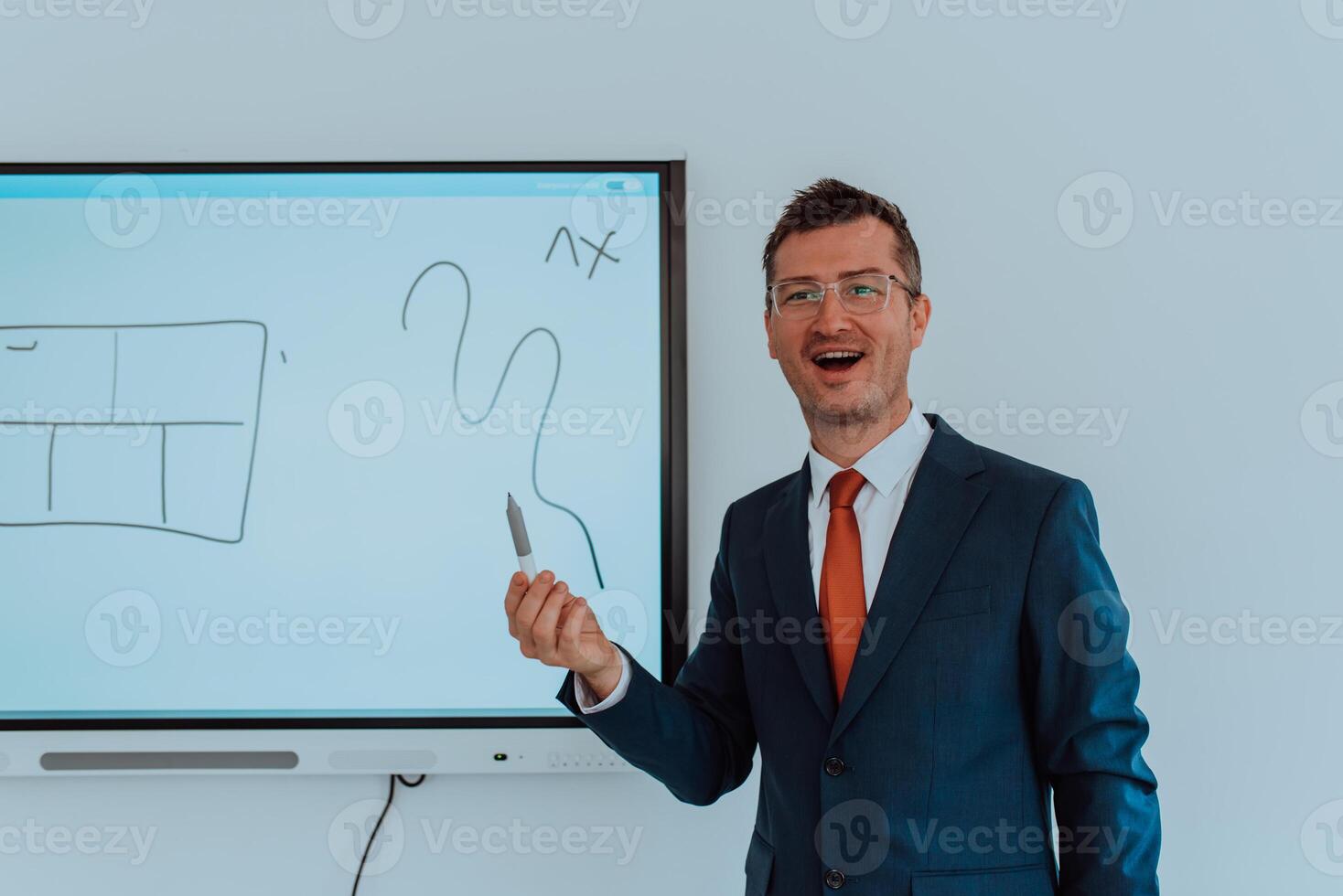 A modernly dressed professor engages in educating students, who listen attentively, creating a dynamic scene of knowledge-sharing and focused learning in the classroom. photo