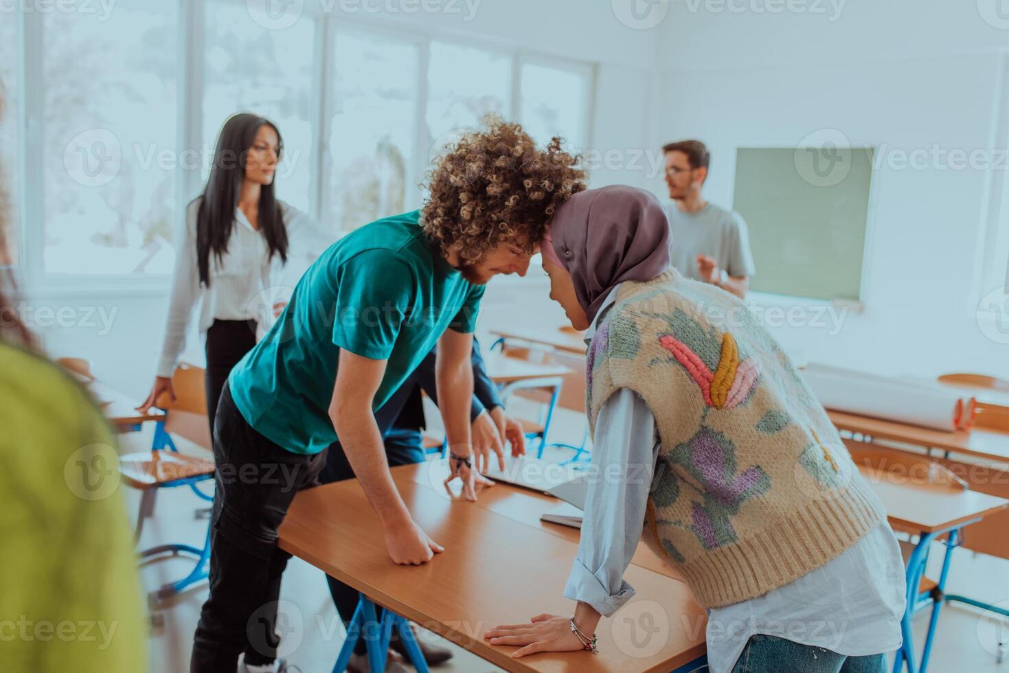 A diverse group of colleagues engages in lighthearted and entertaining activities during a break from a business meeting, showcasing camaraderie, humor, and team bonding in the office photo