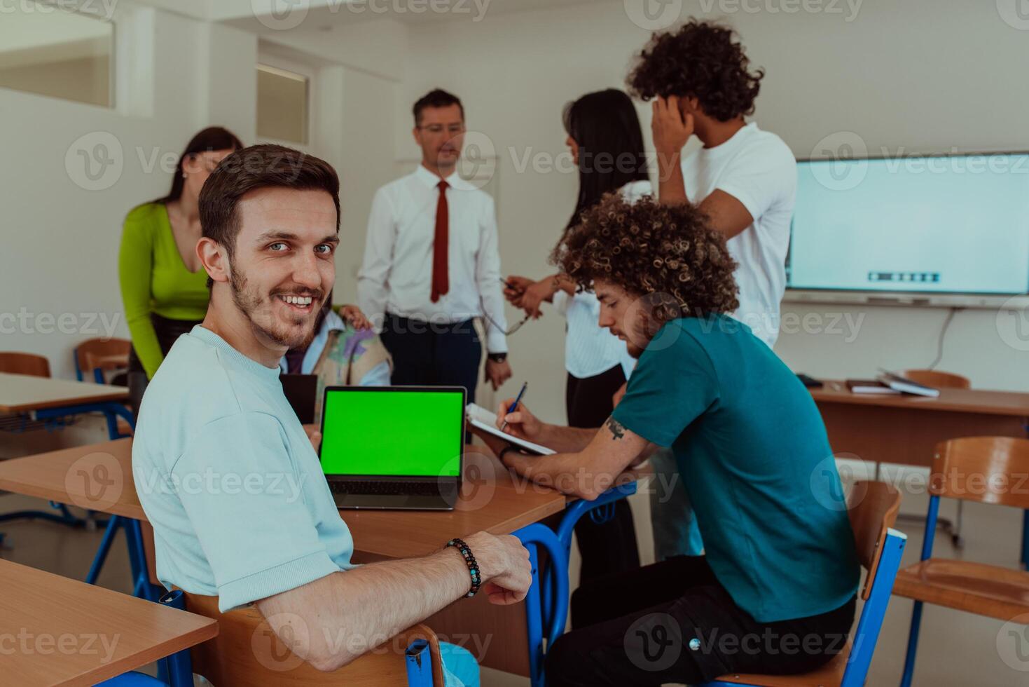 A group of business colleagues exchange knowledge and insights while utilizing laptops in the office, showcasing collaborative learning, effective communication, and a dynamic corporate environment photo