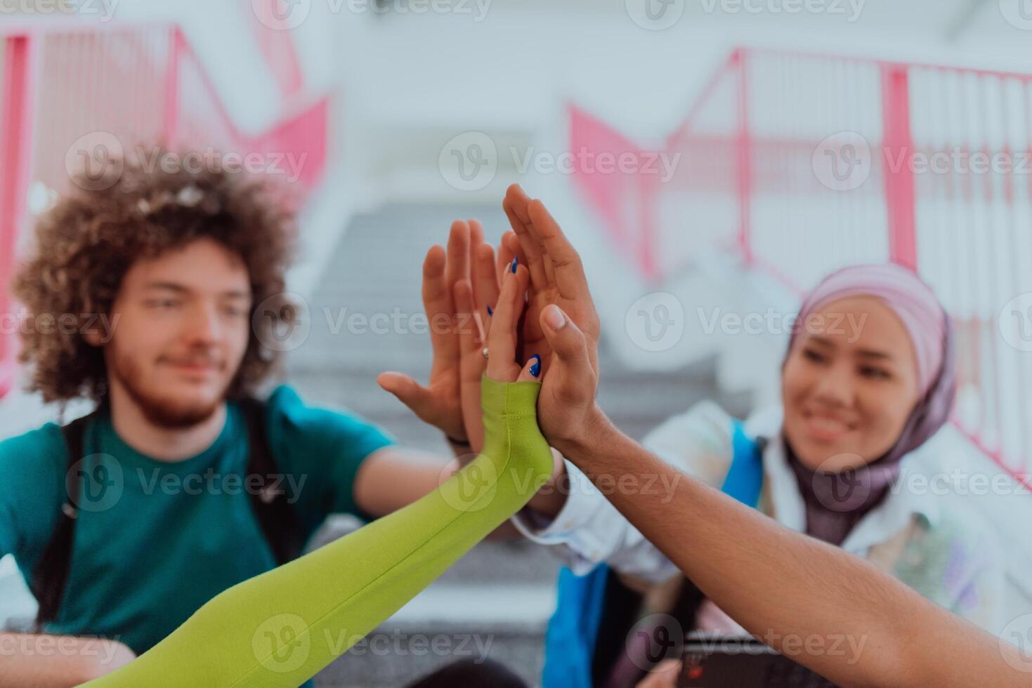 A diverse group of students symbolizes unity as they interlace their hands, portraying a sense of community, collaboration, and inclusive harmony photo
