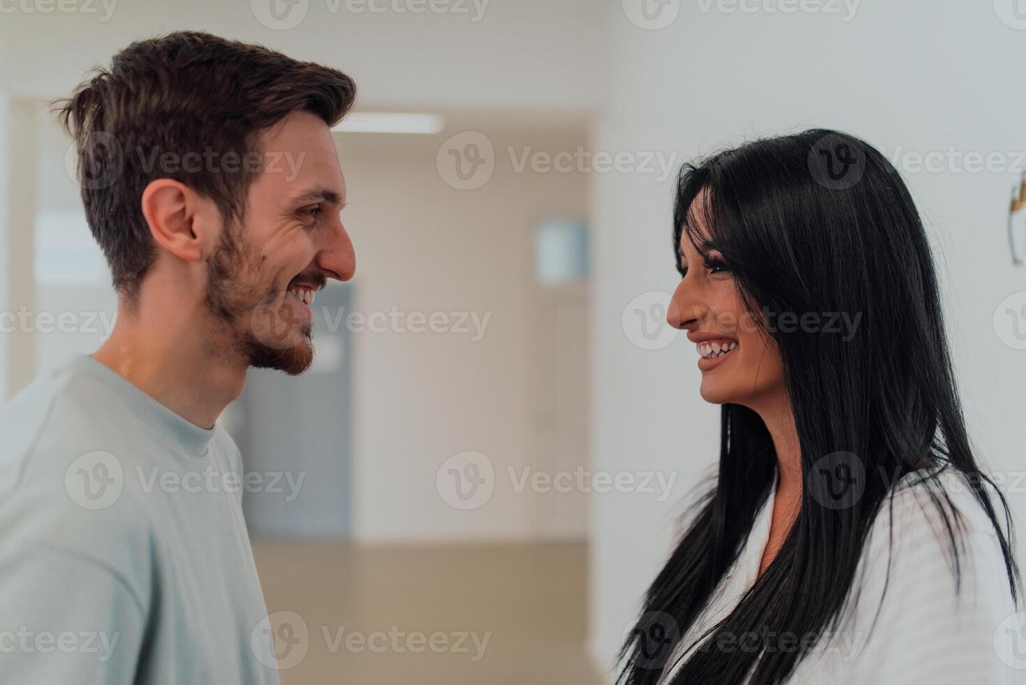 Youn in love students exchange tender emotions while embracing in the university hallway, capturing the essence of their affectionate and joyous relationship during their college days. photo