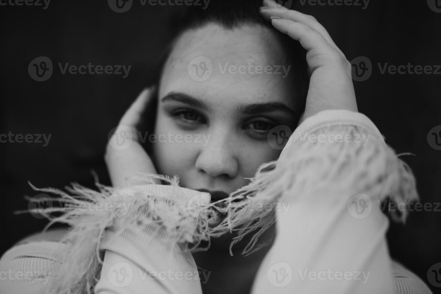 A close-up, unretouched portrait of a naturally beautiful young woman showcasing her authentic and unaltered facial features, capturing the essence of real beauty without any digital enhancements. photo