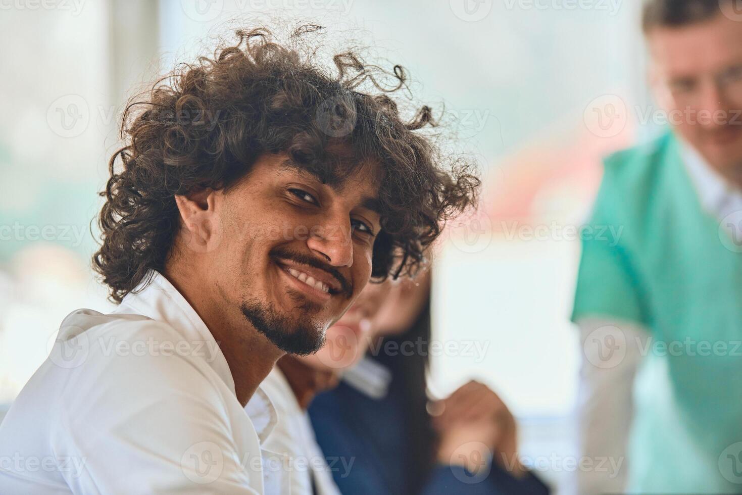 A smiling African American doctor engages in a positive and productive meeting with colleagues, fostering diversity and teamwork in a healthcare setting photo