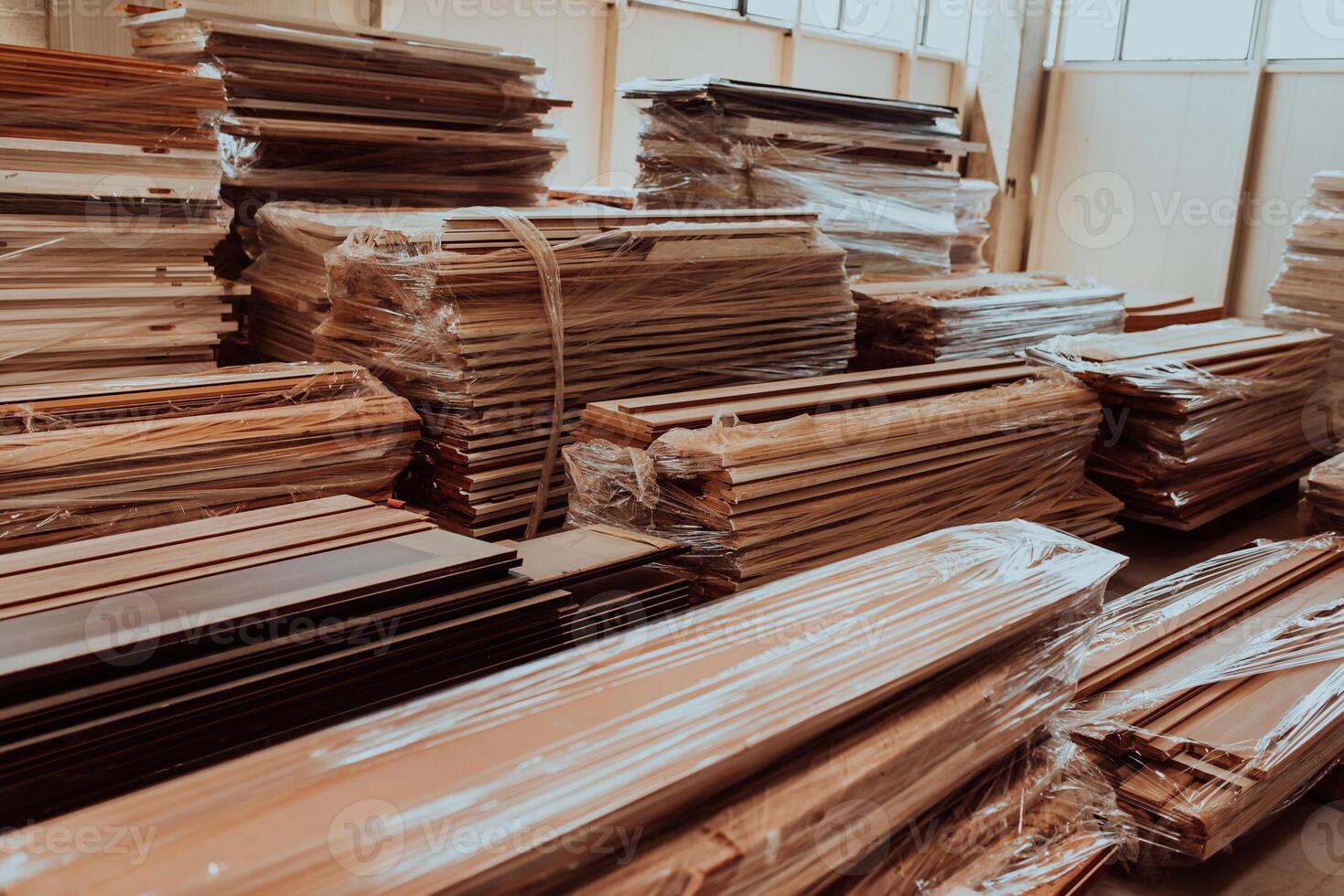 A vast warehouse in the forestry industry, showcasing a plethora of wooden products, including boards and various timber items neatly organized in storage photo