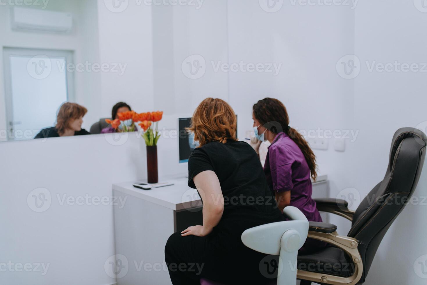 In a modern dental office, a dentist and a young patient engage in a collaborative consultation, exploring new tooth shades and discussing treatment options using a computer photo