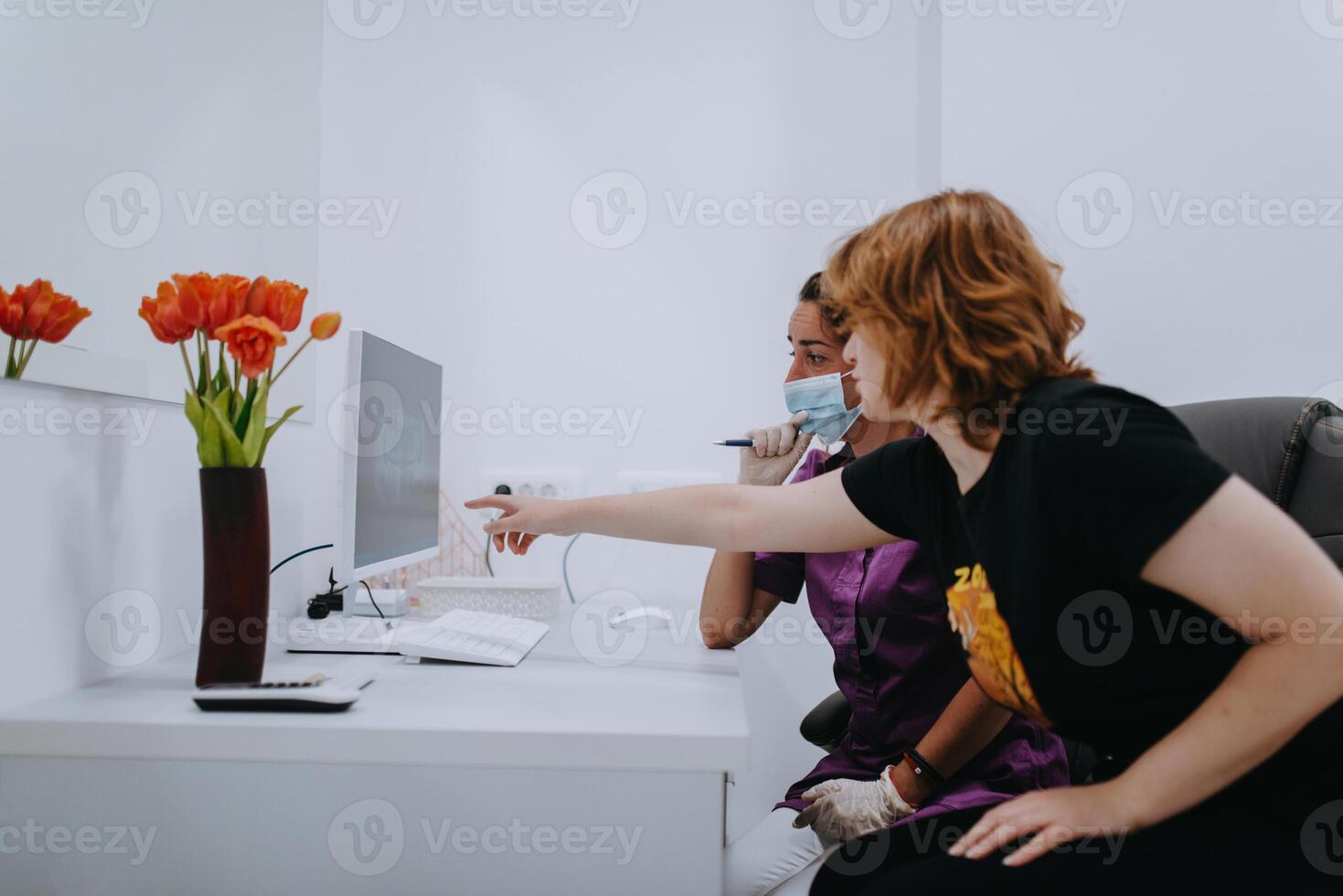 In a modern dental office, a dentist and a young patient engage in a collaborative consultation, exploring new tooth shades and discussing treatment options using a computer photo